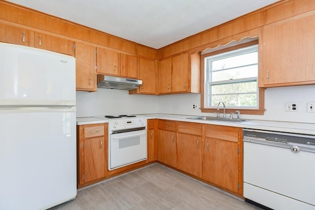 kitchen with white appliances, light countertops, a sink, and under cabinet range hood