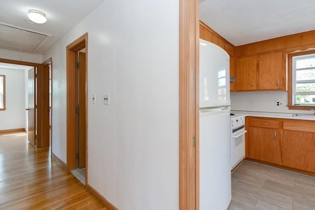 hall featuring attic access and a sink