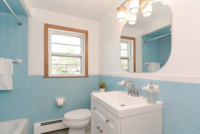 bathroom with toilet, tile walls, wainscoting, a baseboard heating unit, and vanity