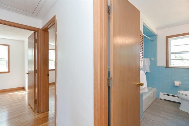interior space with tile walls and baseboard heating