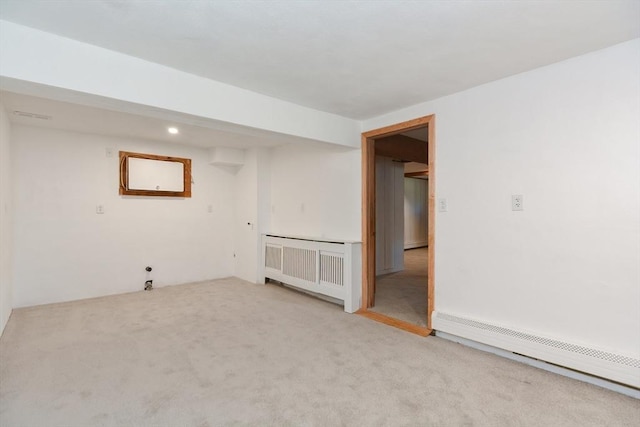 interior space featuring light colored carpet, recessed lighting, radiator, and a baseboard heating unit