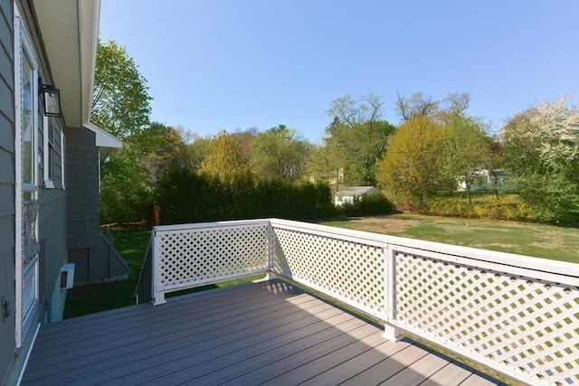 wooden terrace with a lawn