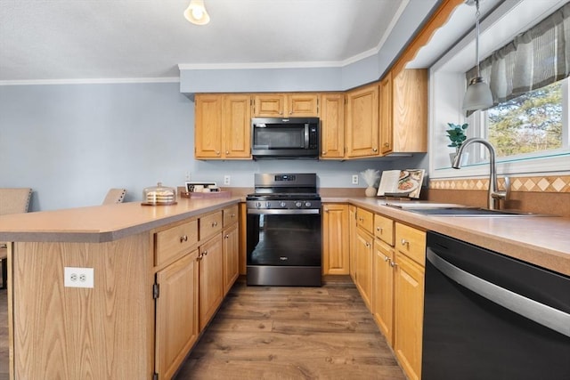 kitchen with pendant lighting, light brown cabinetry, sink, black dishwasher, and stainless steel range with gas stovetop