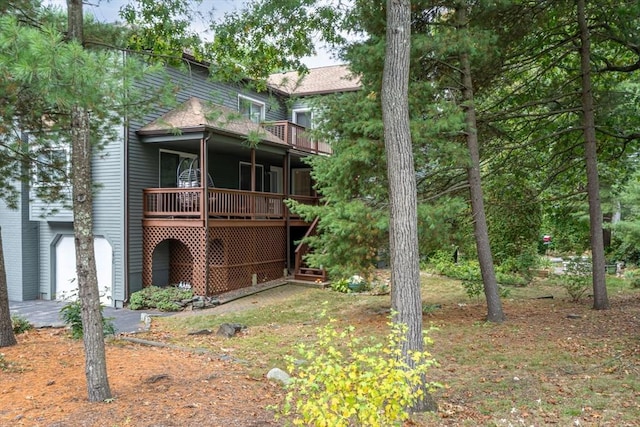 back of house with a wooden deck