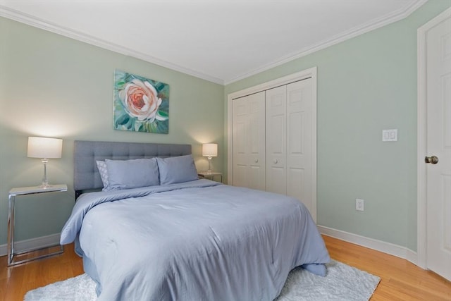 501 Lexington St Unit 35, Waltham, MA 02452 - bedroom with ornamental molding, a closet, light wood-type flooring, and baseboards