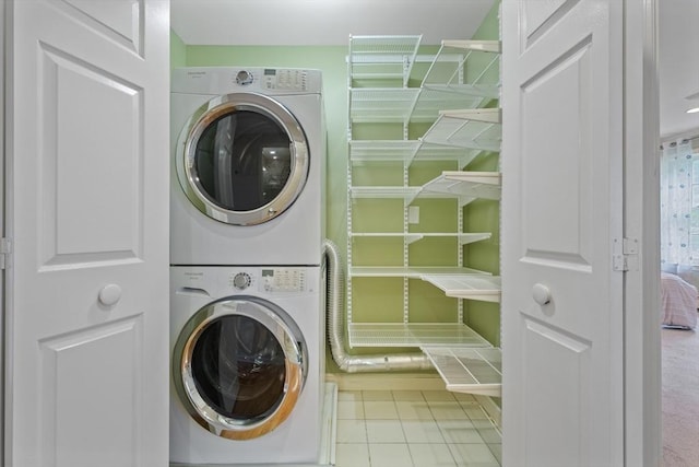 501 Lexington St Unit 35, Waltham, MA 02452 - washroom with stacked washer / dryer and tile patterned floors