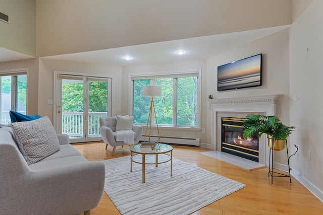 501 Lexington St Unit 35, Waltham, MA 02452 - living area featuring a baseboard radiator, a glass covered fireplace, light wood-type flooring, baseboards, and recessed lighting