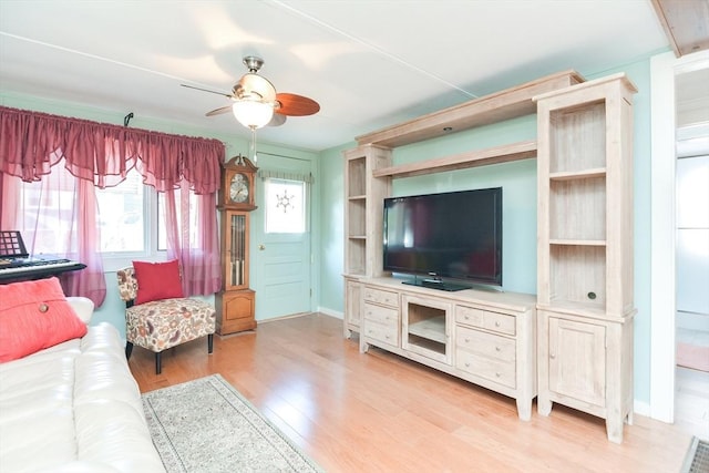 living room with ceiling fan, wood finished floors, and baseboards