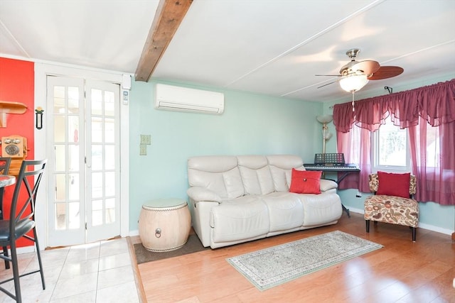 living area with baseboards, a ceiling fan, wood finished floors, beamed ceiling, and a wall mounted air conditioner