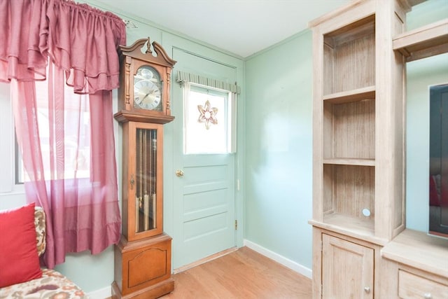 doorway featuring light wood-style floors and baseboards