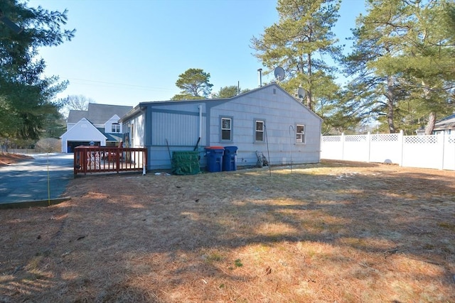 back of property featuring fence