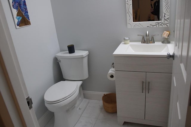 bathroom featuring vanity, marble finish floor, baseboards, and toilet