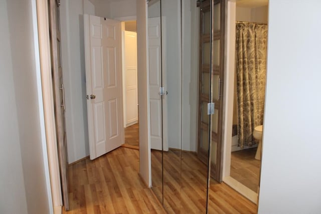 corridor featuring light wood-style flooring