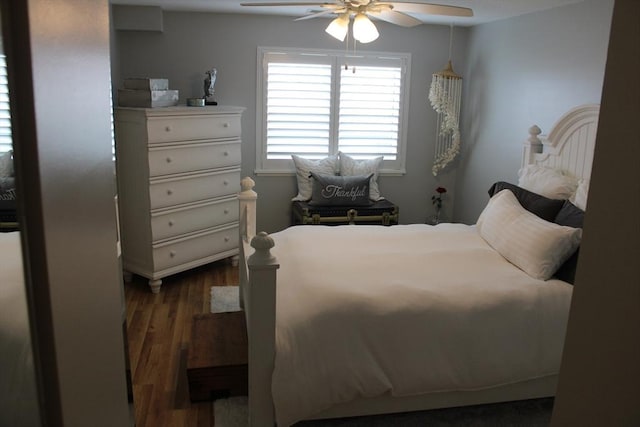 bedroom with a ceiling fan and dark wood-type flooring