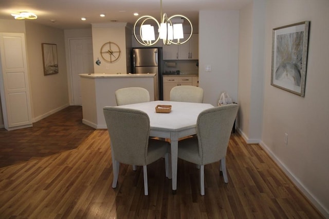 dining space with recessed lighting, baseboards, an inviting chandelier, and dark wood-type flooring