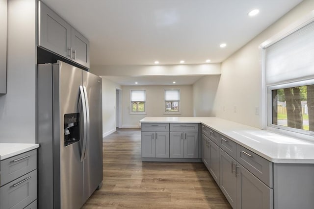 53 Kalish Ave, Enfield, CT 06082 - kitchen featuring stainless steel fridge, gray cabinets, a peninsula, light wood-style flooring, and light countertops
