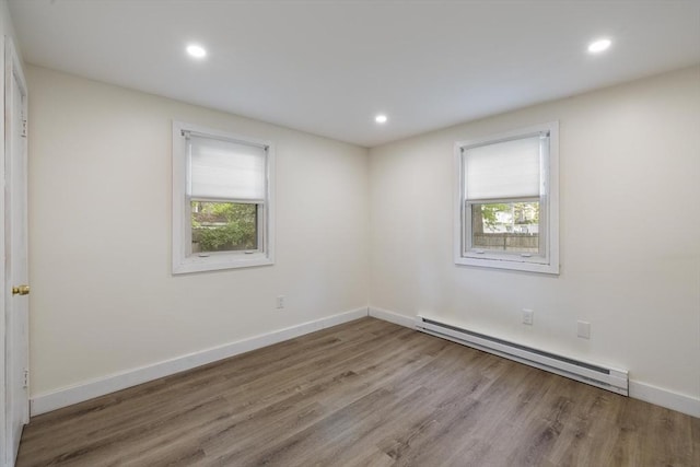 53 Kalish Ave, Enfield, CT 06082 - empty room featuring baseboard heating, healthy amount of natural light, wood finished floors, and recessed lighting