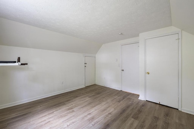 53 Kalish Ave, Enfield, CT 06082 - additional living space featuring wood finished floors, vaulted ceiling, a textured ceiling, and baseboards