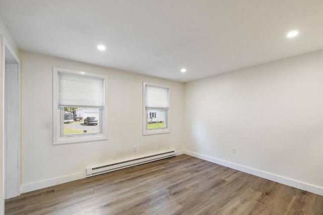 53 Kalish Ave, Enfield, CT 06082 - spare room with a baseboard heating unit, wood finished floors, recessed lighting, and baseboards
