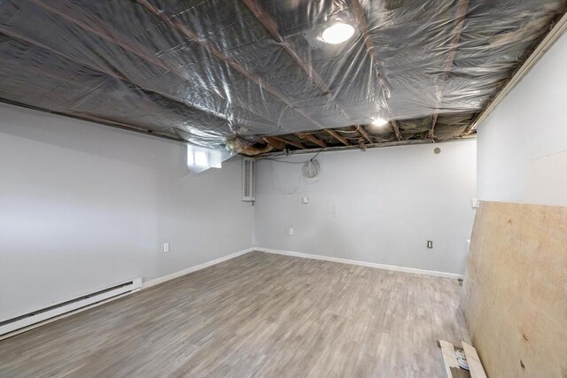 53 Kalish Ave, Enfield, CT 06082 - below grade area featuring baseboard heating, wood finished floors, and baseboards