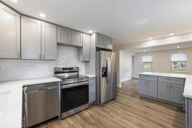 53 Kalish Ave, Enfield, CT 06082 - kitchen with appliances with stainless steel finishes, gray cabinets, light countertops, decorative backsplash, and recessed lighting