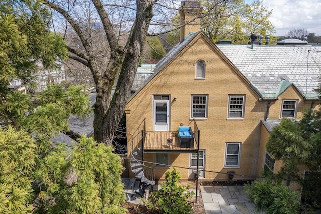 30 Cumberland Unit W-4, Brookline, MA 02445 - back of property with brick siding, a chimney, and a patio area