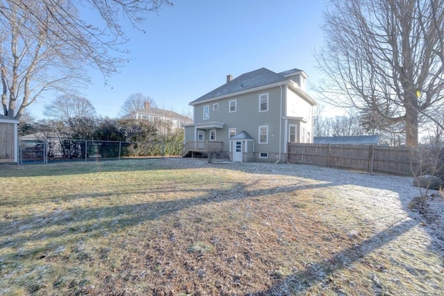 rear view of property featuring a yard