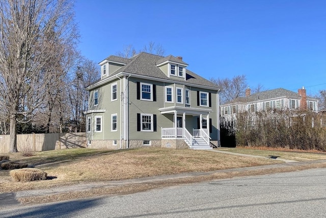 view of front of property with covered porch and a front yard