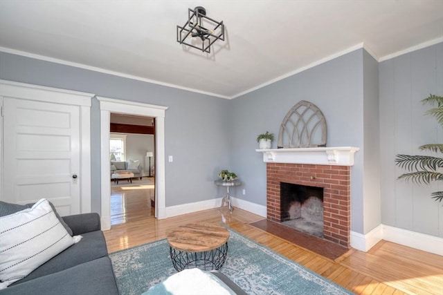 living room featuring wood-type flooring, a brick fireplace, and ornamental molding