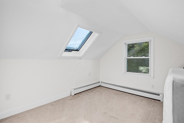 bonus room featuring a baseboard heating unit, light carpet, and vaulted ceiling