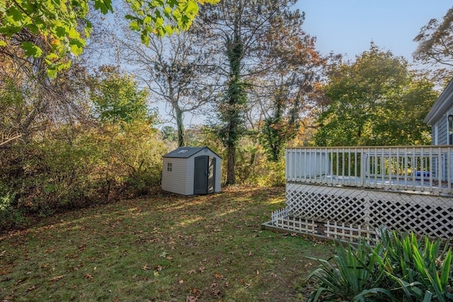 view of yard with a storage shed and a deck