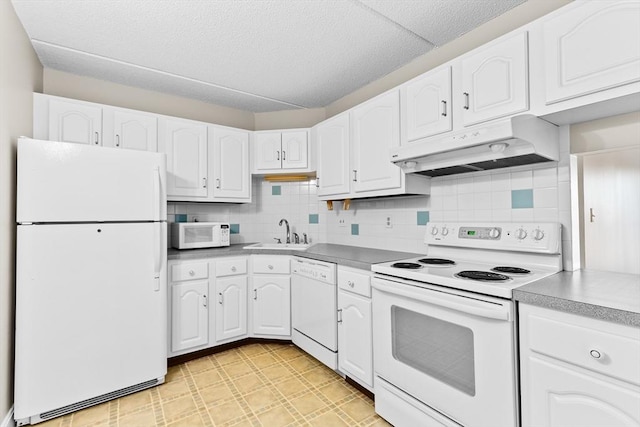 kitchen with white cabinetry, sink, white appliances, and tasteful backsplash