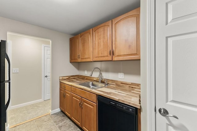 127 King St Unit 104, Franklin, MA 02038 - kitchen featuring dishwasher, a sink, freestanding refrigerator, wood counters, and baseboards