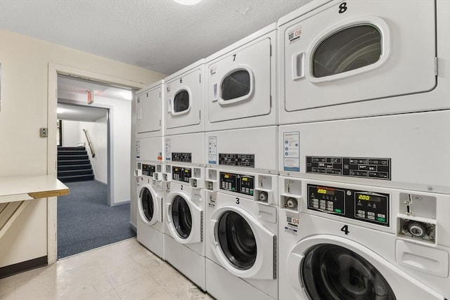 127 King St Unit 104, Franklin, MA 02038 - community laundry room featuring stacked washer / drying machine, washing machine and clothes dryer, light colored carpet, and a textured ceiling