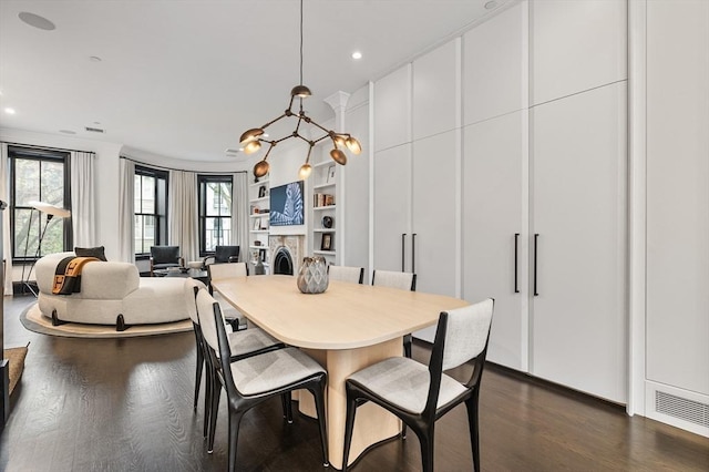 8 Rutland Sq Unit 2, Boston, MA 02118 - dining room featuring dark wood-style floors, built in shelves, recessed lighting, and a fireplace