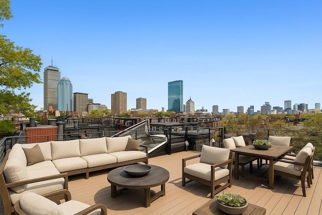 8 Rutland Sq Unit 2, Boston, MA 02118 - wooden deck featuring a view of skyline and an outdoor living space