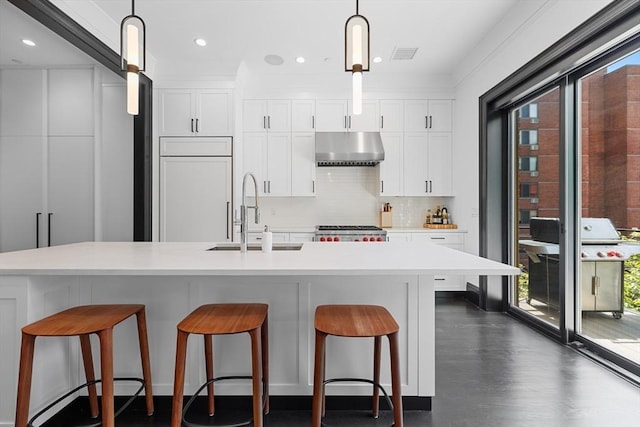 8 Rutland Sq Unit 2, Boston, MA 02118 - kitchen with a sink, under cabinet range hood, range, a kitchen breakfast bar, and pendant lighting