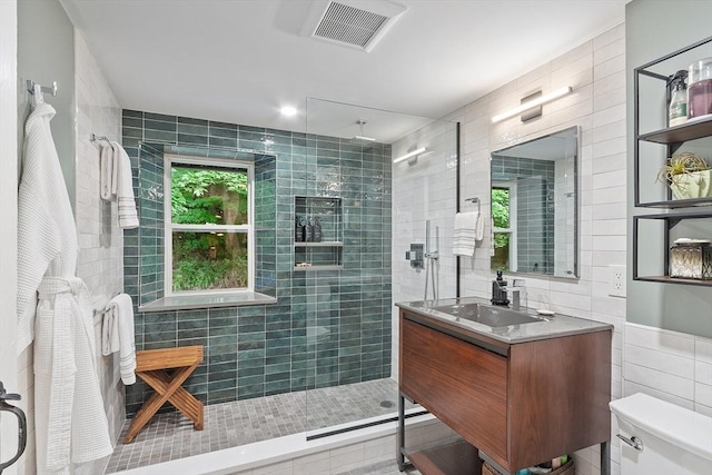 18 River St Unit 18, Andover, MA 01810 - bathroom featuring tile walls, tiled shower, and vanity