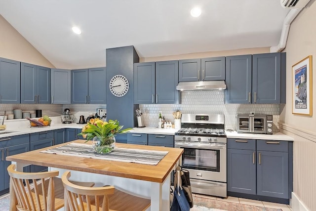 18 River St Unit 18, Andover, MA 01810 - kitchen featuring gas range, under cabinet range hood, wooden counters, backsplash, and vaulted ceiling