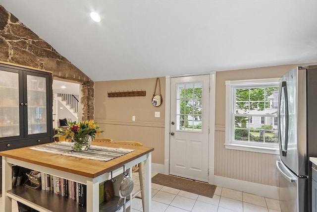 18 River St Unit 18, Andover, MA 01810 - doorway to outside featuring wainscoting, stairway, light tile patterned floors, and lofted ceiling