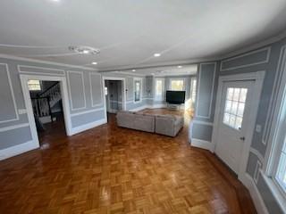 unfurnished living room with parquet floors