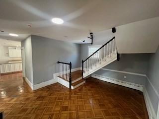 stairs featuring parquet floors