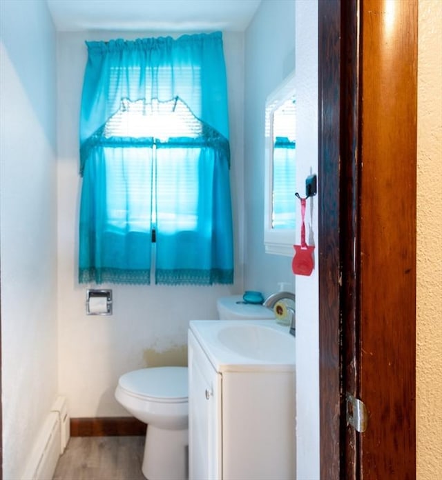 76 Blackstone River Rd, Worcester, MA 01607 - half bath with vanity, toilet, wood finished floors, and baseboard heating