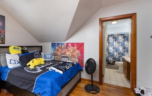 76 Blackstone River Rd, Worcester, MA 01607 - bedroom with vaulted ceiling, wood finished floors, and connected bathroom