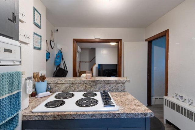 76 Blackstone River Rd, Worcester, MA 01607 - kitchen featuring radiator heating unit, white electric cooktop, baseboard heating, blue cabinets, and light countertops