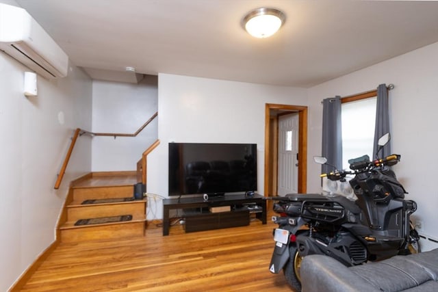 76 Blackstone River Rd, Worcester, MA 01607 - living room with a wall mounted air conditioner, wood finished floors, and stairs