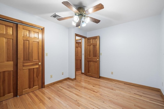 unfurnished bedroom with ceiling fan and light wood-type flooring