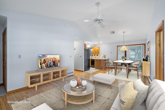 living room featuring baseboard heating, ceiling fan, lofted ceiling, and light hardwood / wood-style floors