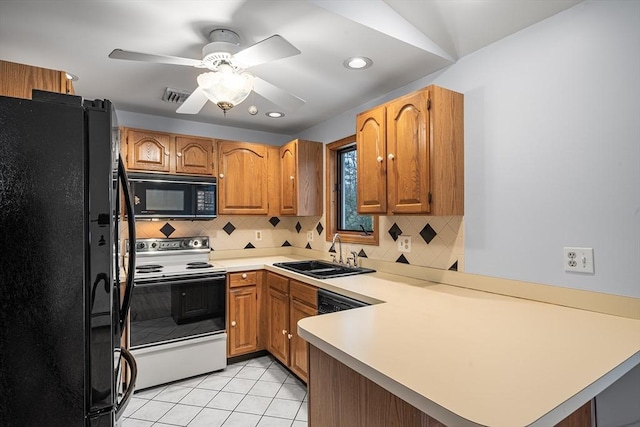 kitchen with light tile patterned flooring, sink, black appliances, kitchen peninsula, and backsplash