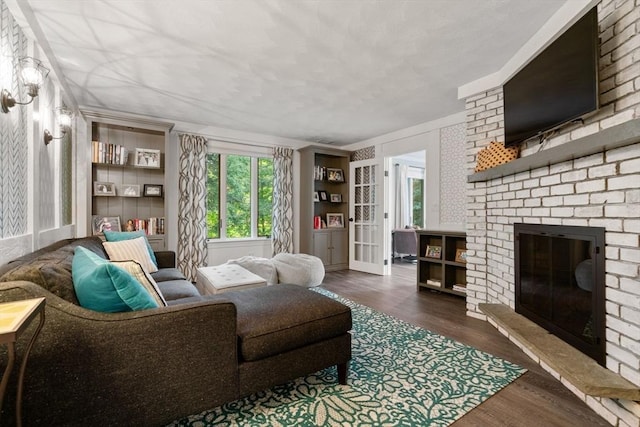 19 Buckmaster Dr, Sudbury, MA 01776 - living area with a brick fireplace, a healthy amount of sunlight, and wood finished floors